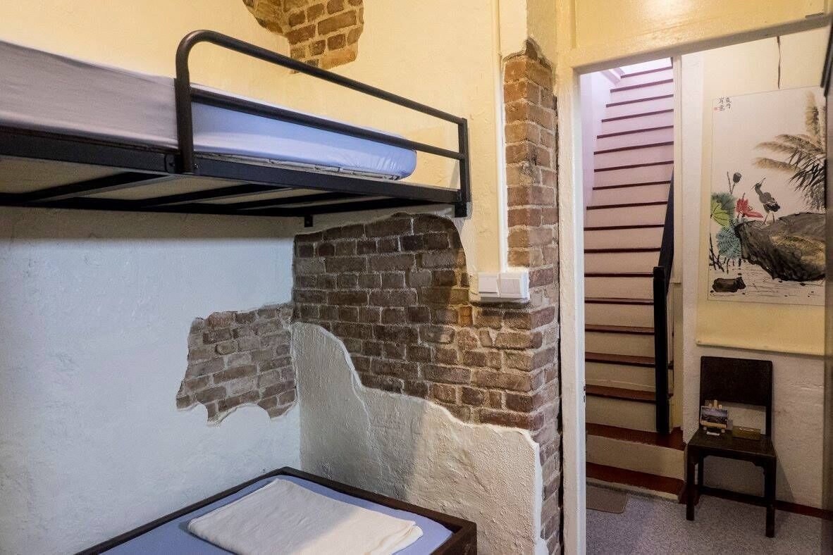 Monkey triple room with one single bed and one bunk bed at Sojourn Beds & Cafe in Taiping