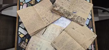 Open guestbooks at Sojourn Beds & Cafe with handwritten notes, sketches and memories from travellers