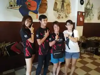 A group of travellers smiling together inside Sojourn Beds & Cafe in Taiping
