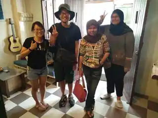 Four travellers posing together during their stay at Sojourn Beds & Cafe in Taiping