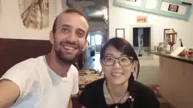 Two guests smiling together at Sojourn Beds & Cafe in Taiping